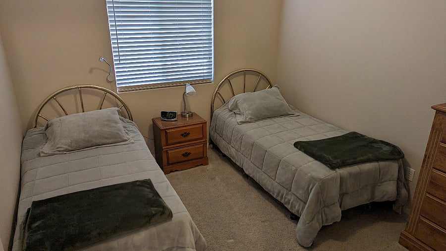 Two twin extra long twin beds across from the full size hall bathroom