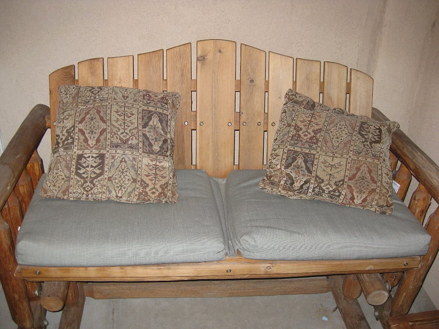 Rocking bench on the patio area of the condo.
