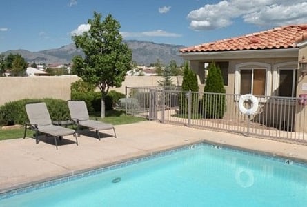 Northwest Clubhouse with pool looking EAST towards Sandia Mountains -- OPENED SEASONALL  - please call/text/email for hours of operation