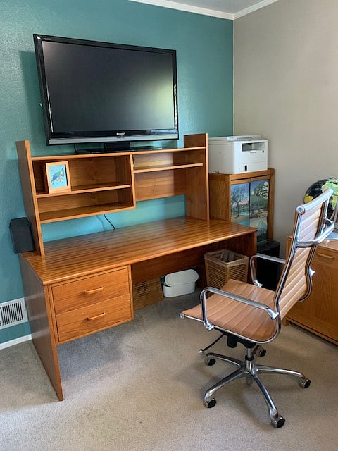 Large desk with ergonomic chair and 42" monitor