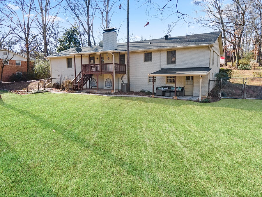 1/2 acre fenced back yard with 2 outdoor seating cozy areas