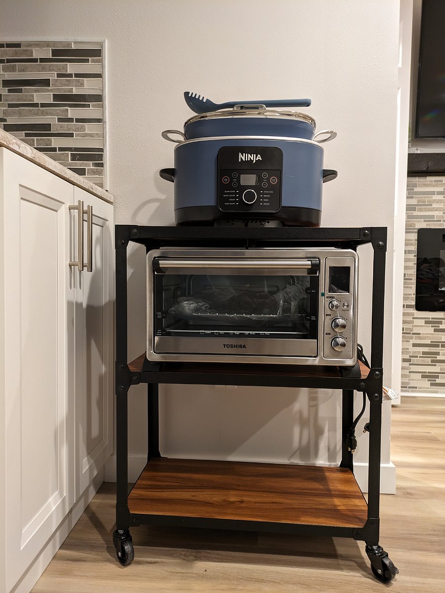 Additional kitchentte appliances: Ninja Foodi Possible Cooker PRO and Toshiba 10 in 1 countertop convection toaster oven, both on a rolling cart.