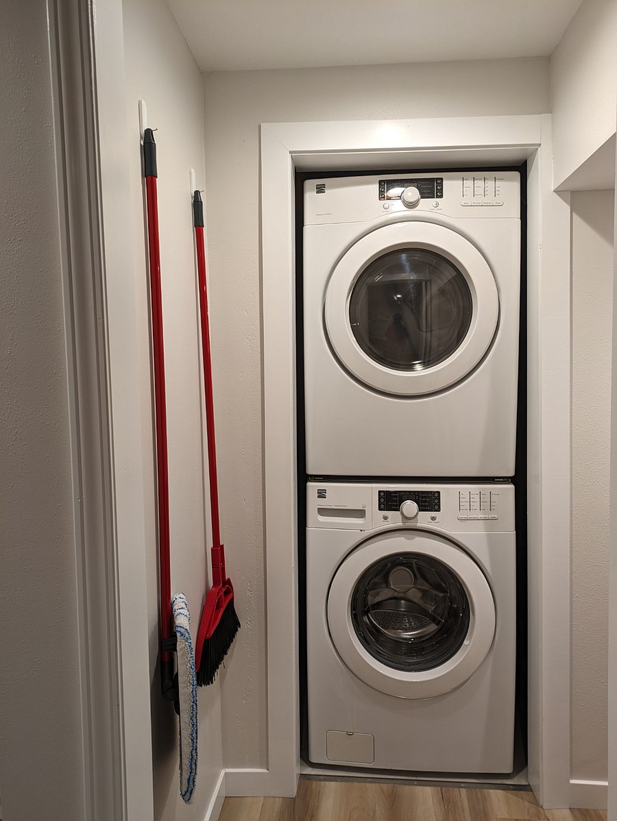 In unit shared large capacity washer and dryer in laundry room. Cleaning tools provided for tenant use.