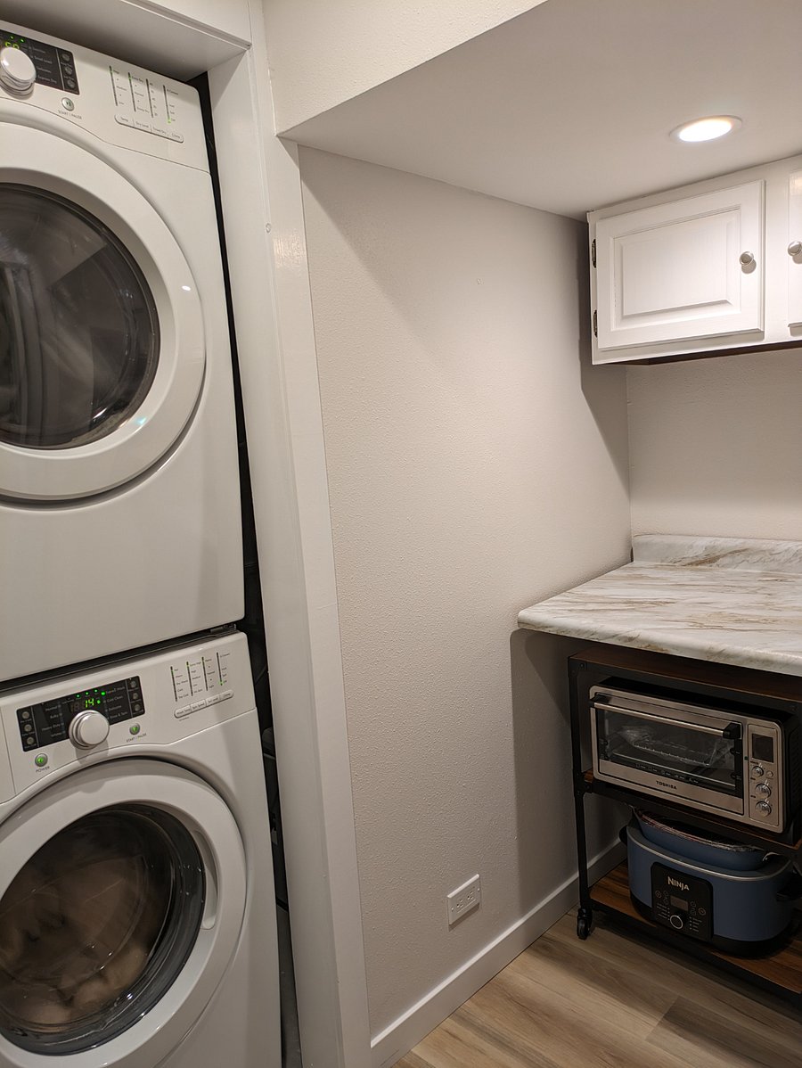 Shared in unit washer and dryer: Tenant starter laundry soap, dryer sheets and iron provided in cabinet. Apartment sized refrigerator and ironing board. Kitchenette appliances are on a rolling cart.