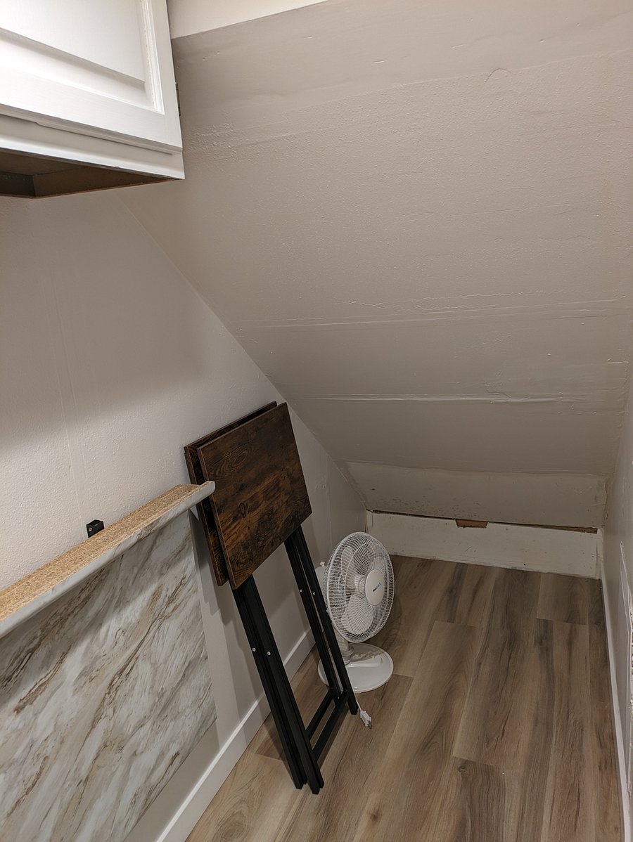 In-unit tenant storage space under stairs. Dining trays, vacuum, storage bins and portable fan/heater for tenant use.
