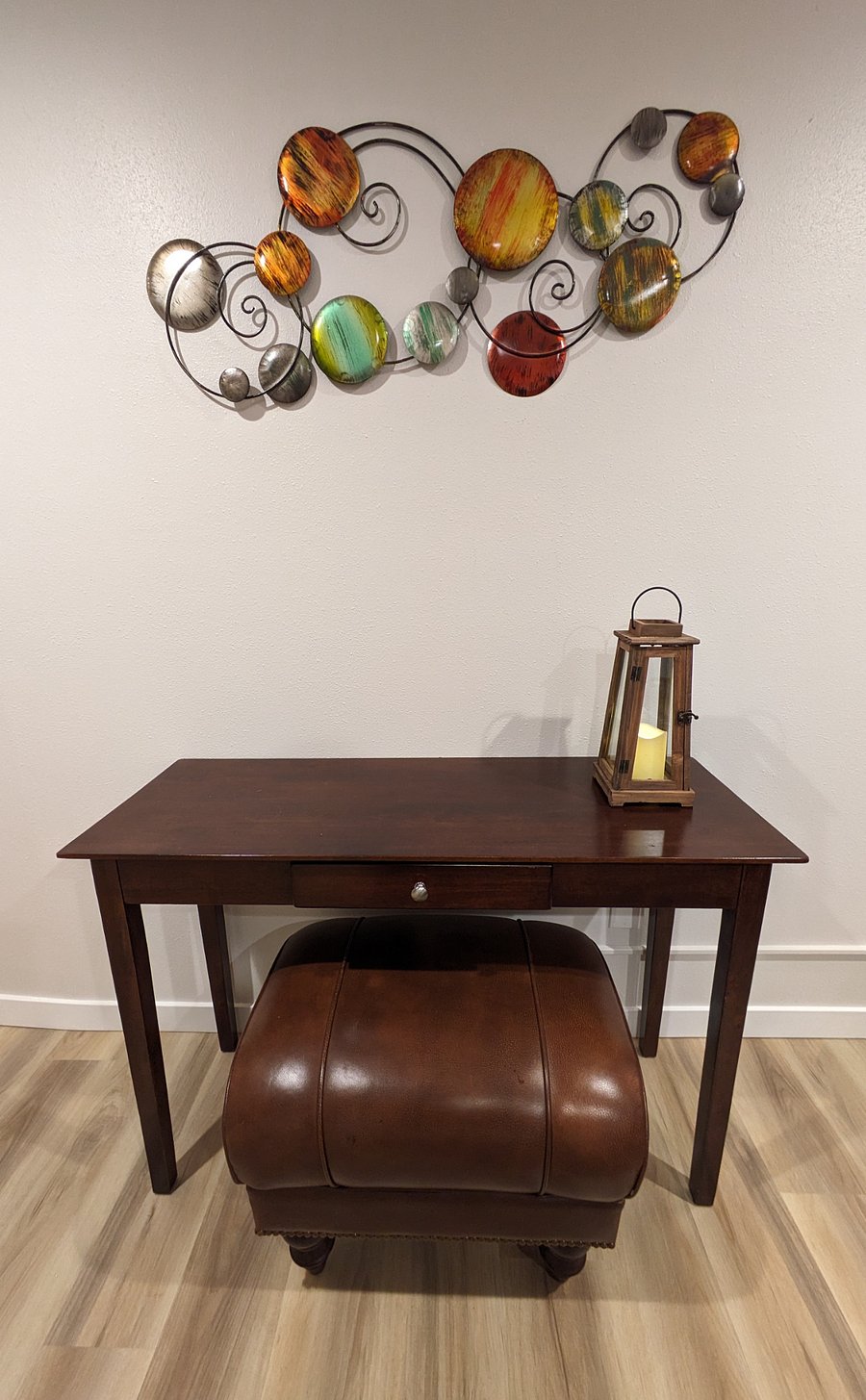 Living area table with drawer and ottoman.