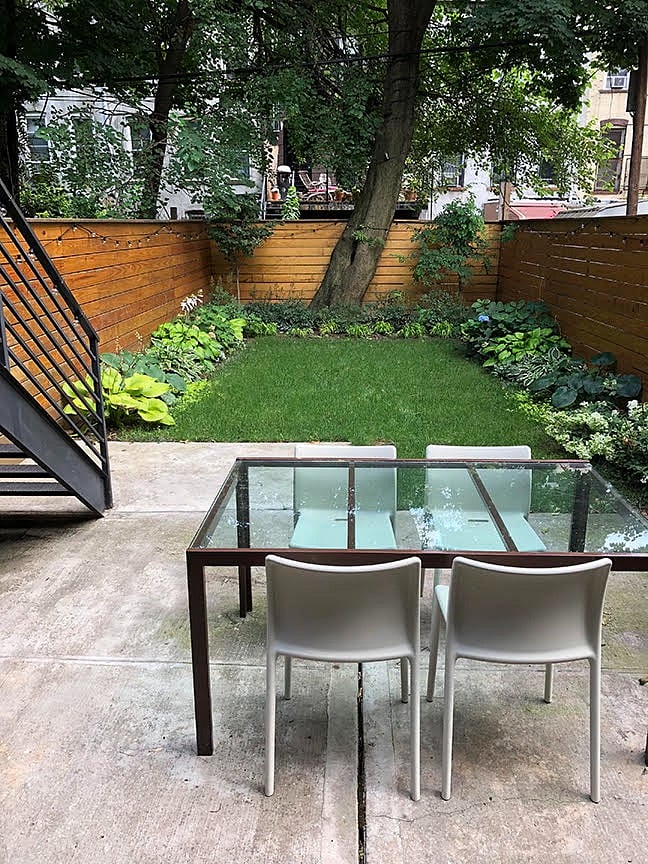 walk out to patio area with gas grill and dining area and shared back yard