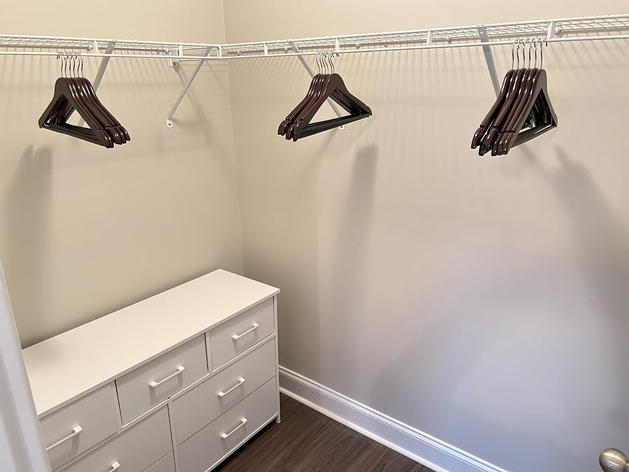Private attached walk-in wardrobe with dresser
