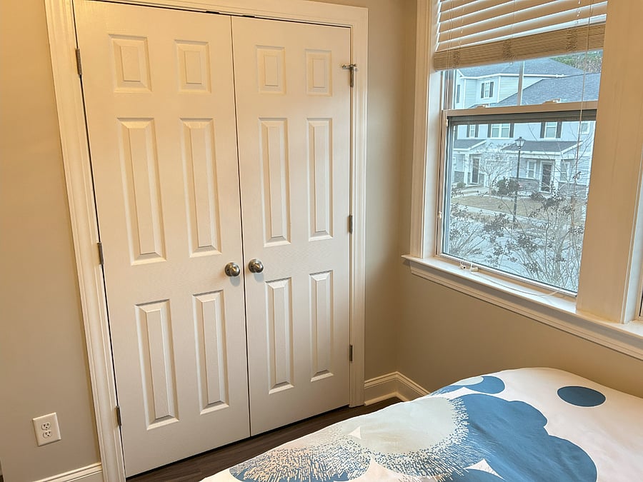 Downstairs bedroom with WFH setup including printer and monitor