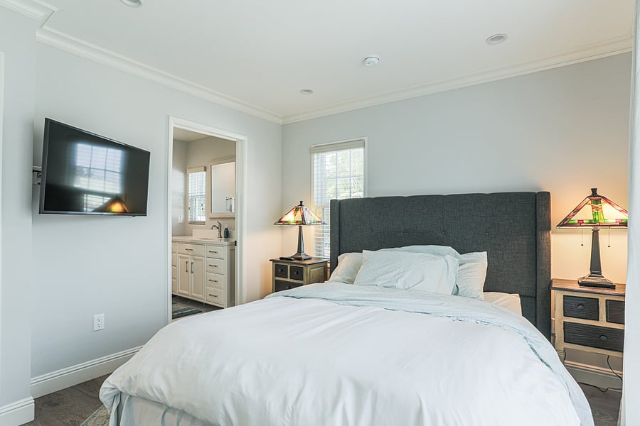 Primary Bedroom (Bedroom #3) with its own en-suite bathroom featuring 1 queen bed and a walk in closet along with an outdoor patio.