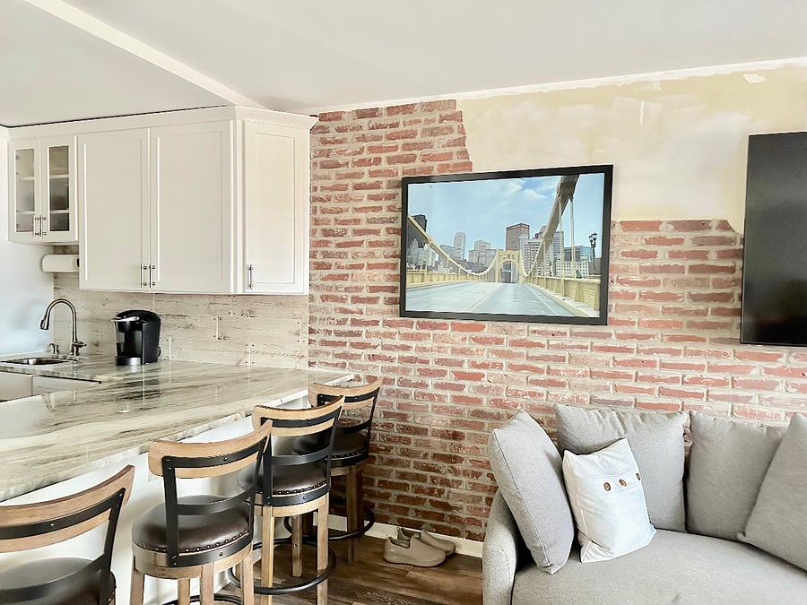 Tasteful real brick wall accent and a large island with plenty of seating.