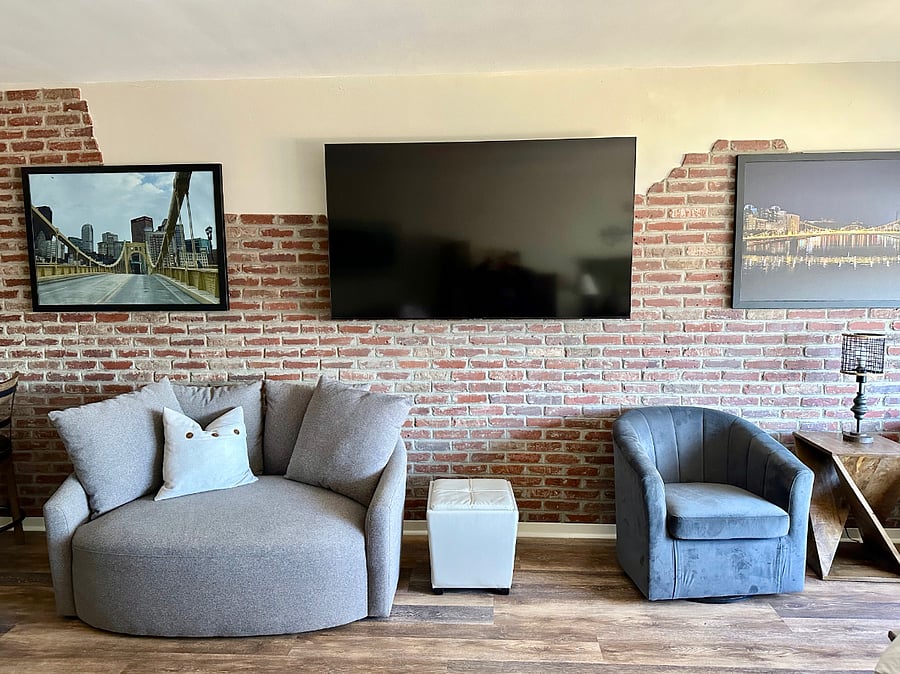 Large 60" Smart TV and swivel love seat.