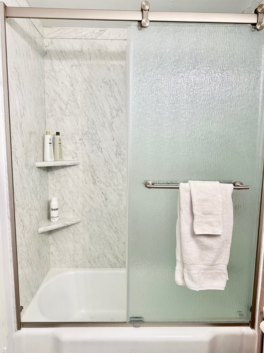 Newly renovated extra tall shower/ bathtub with shampoo, conditioner and shower gel.