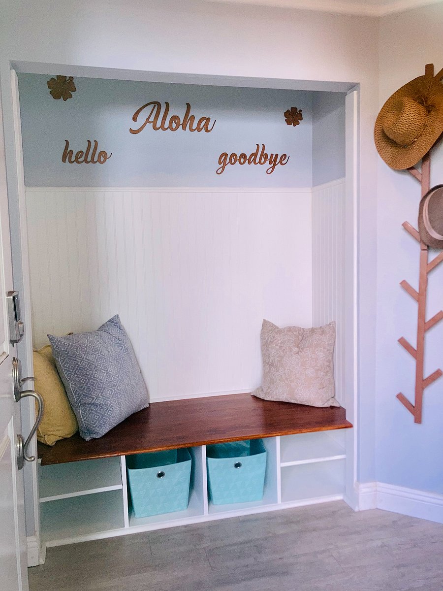 Welcoming entry way bench with coat rack, shoe cubbies, and complimentary guest slippers for added comfort.