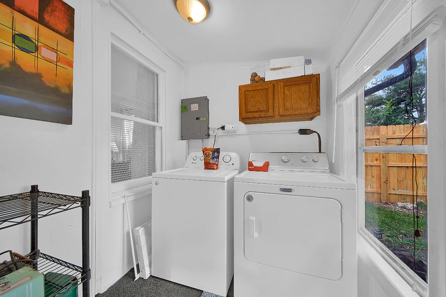 Laundry room is stocked with laundry soap, fabric softener.