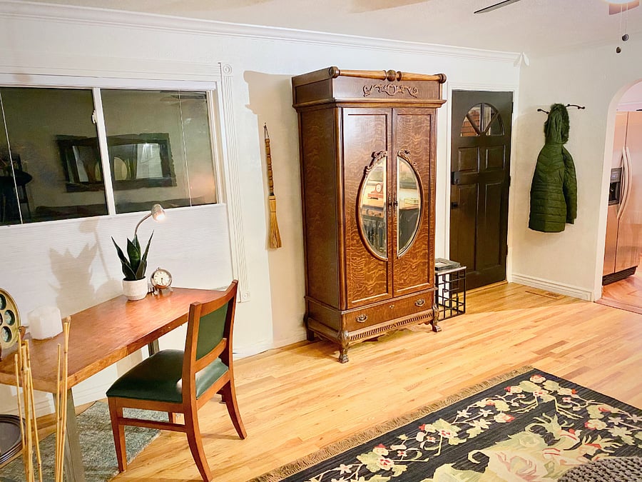 View from sofa to the front door and peeking into the kitchen.