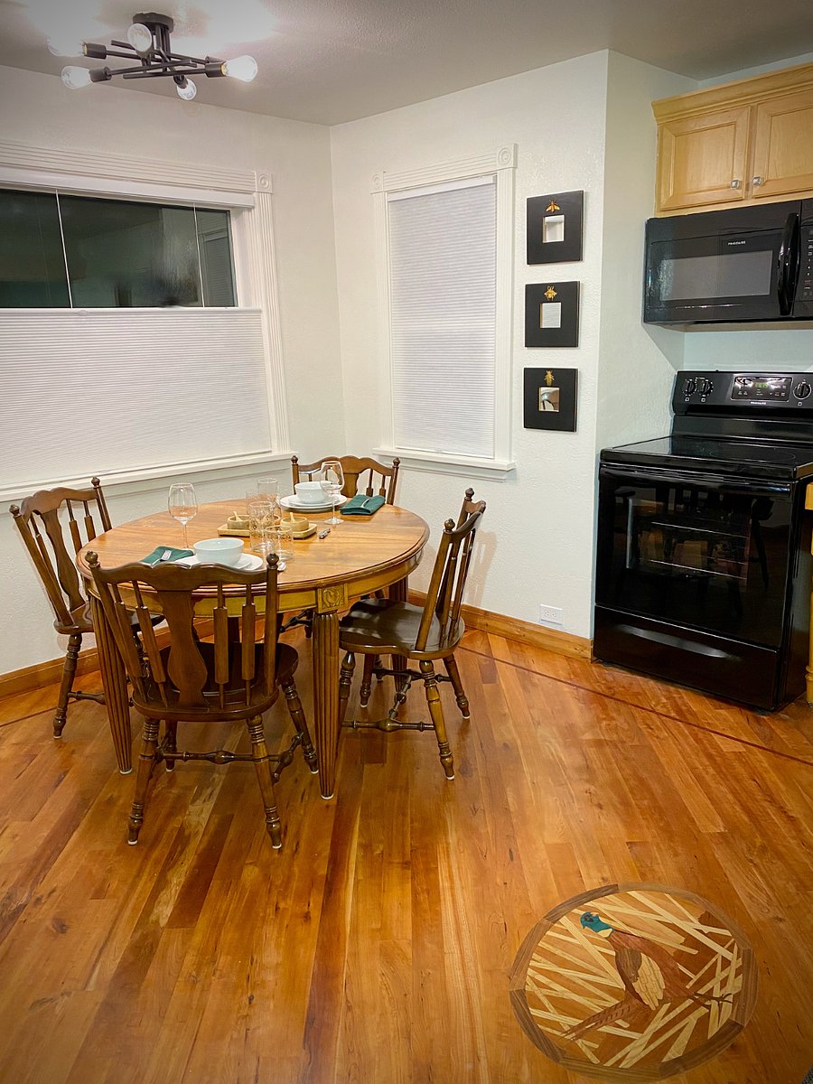 Dining table for 4 and new stove/microwave.  Large windows with up/down cellular shades.