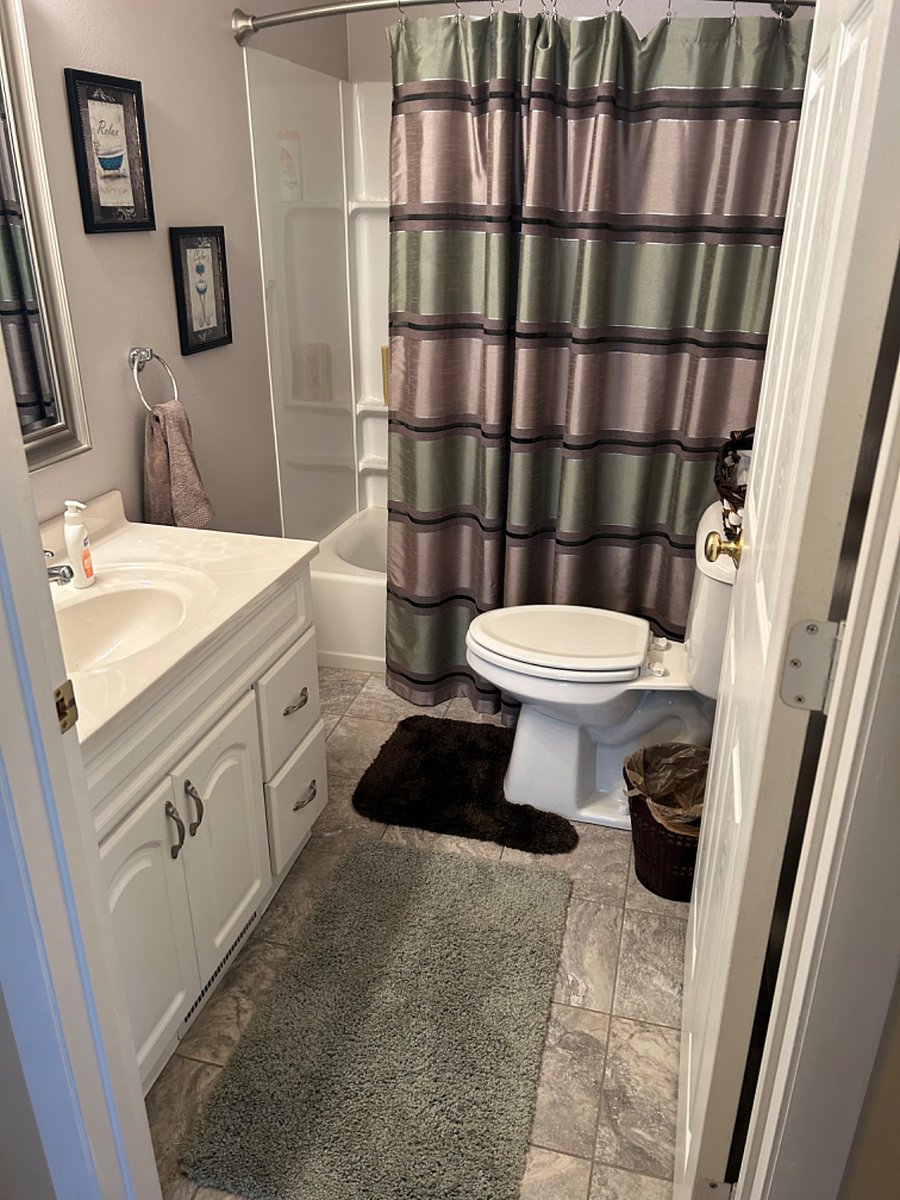Secondary bath with tub and shower.