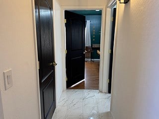 hallways between bedroom 7, downstairs bathroom, and office