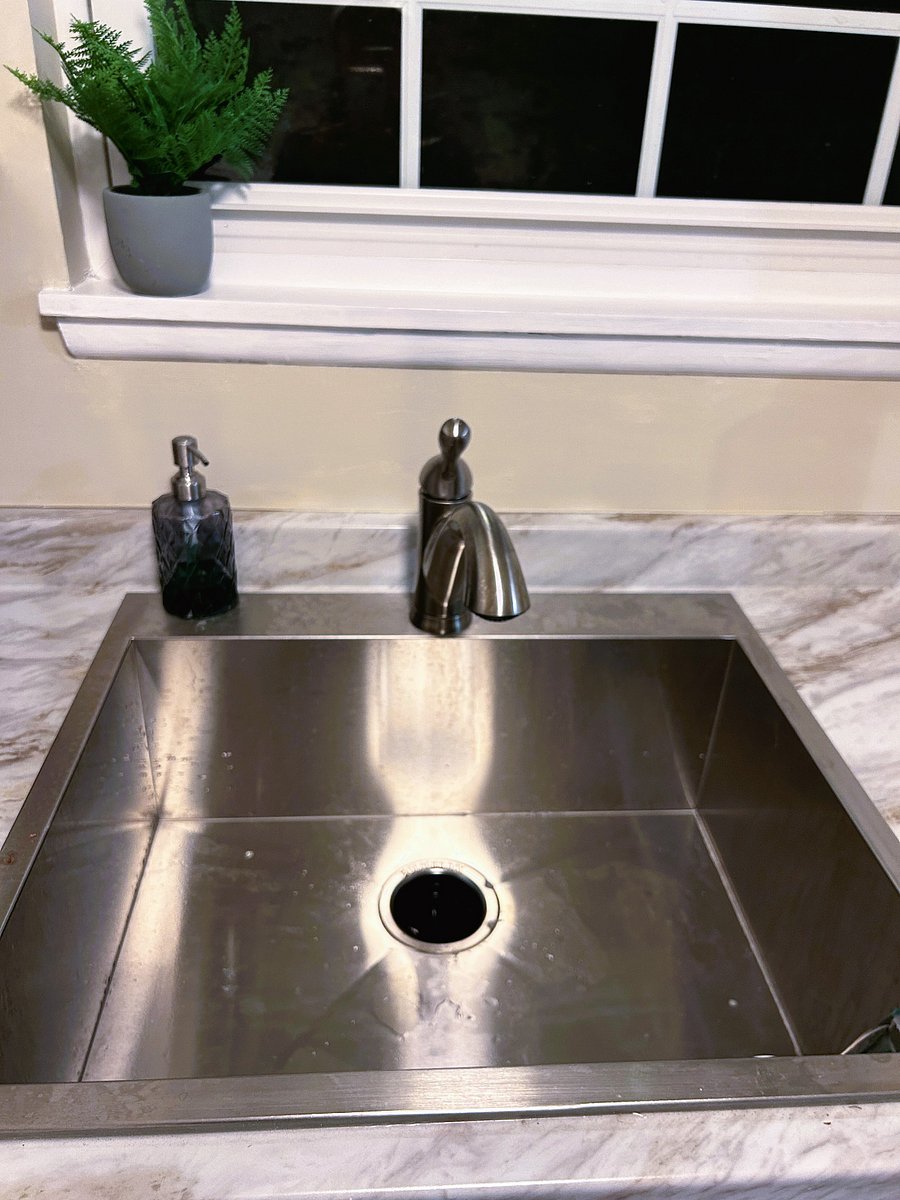 New deep stainless steel sink make clean up a breeze. Faucet has pull-out sprayer.