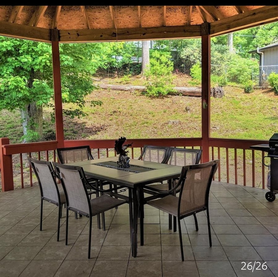 Gazeebo with lights, sitting areas and fire pit. Overlooking backyard and mountains