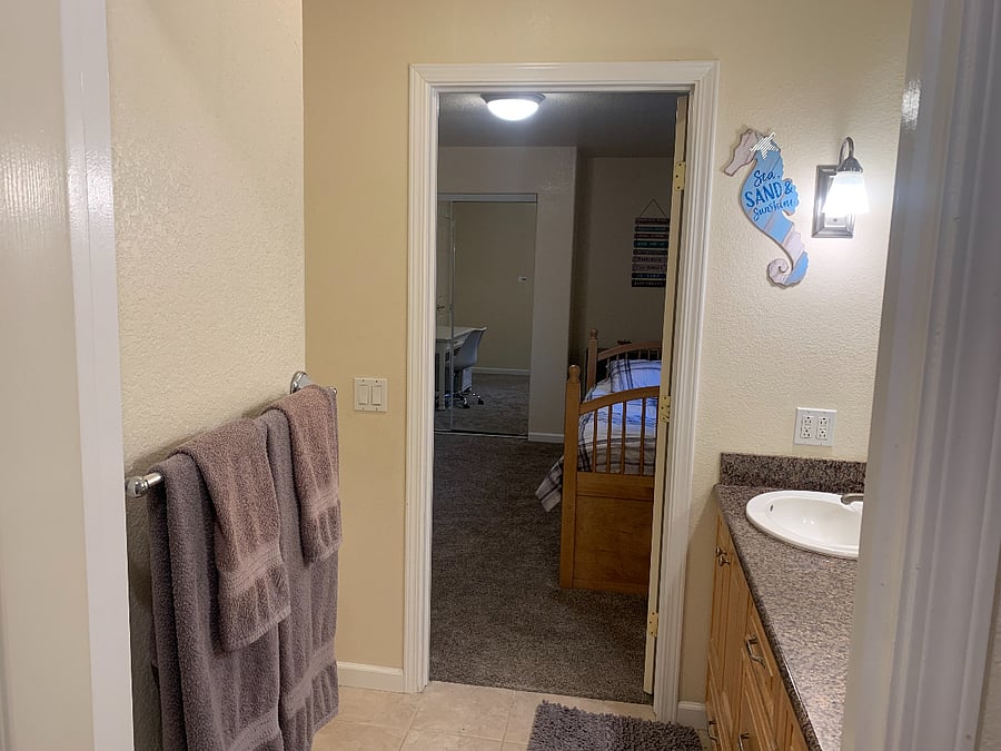 View from toilet/bath/shower area of bathroom looking into interior door of room for rent