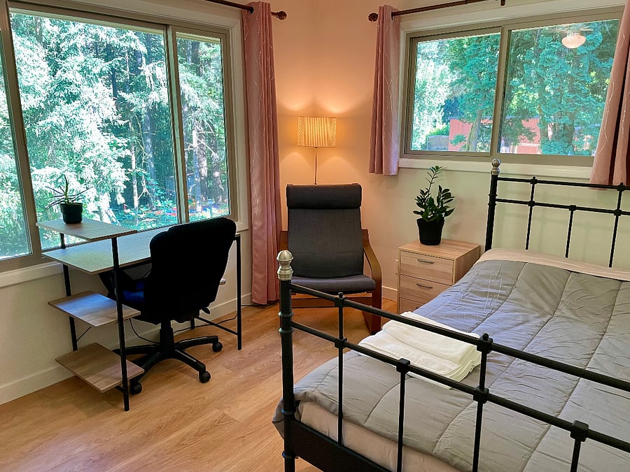 Full bedroom with desk and lounge chair