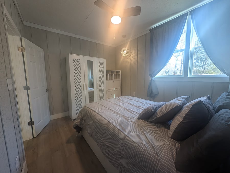 bedroom with double bed, wardrobe and desk