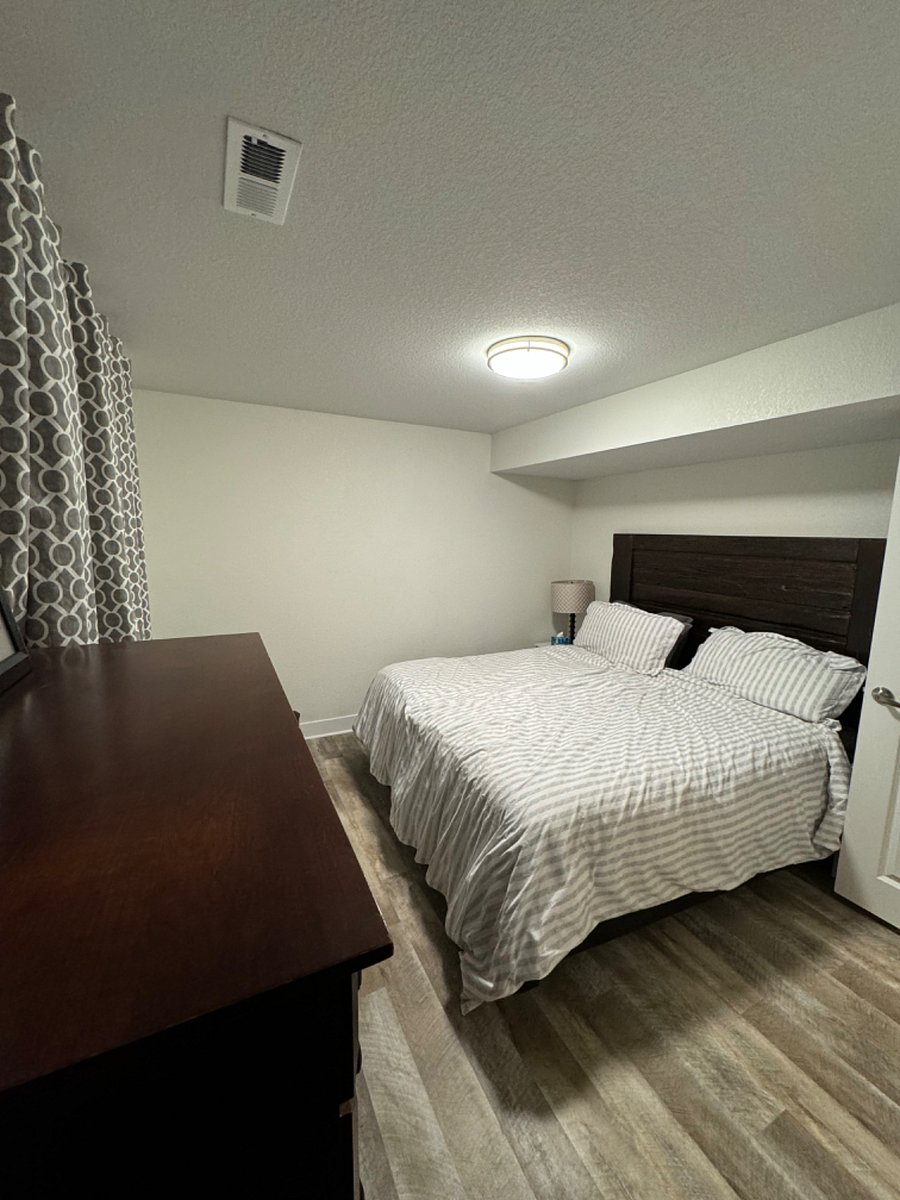 Bedroom with King Size Bed, Full Closet, Dresser and 2 Chairs