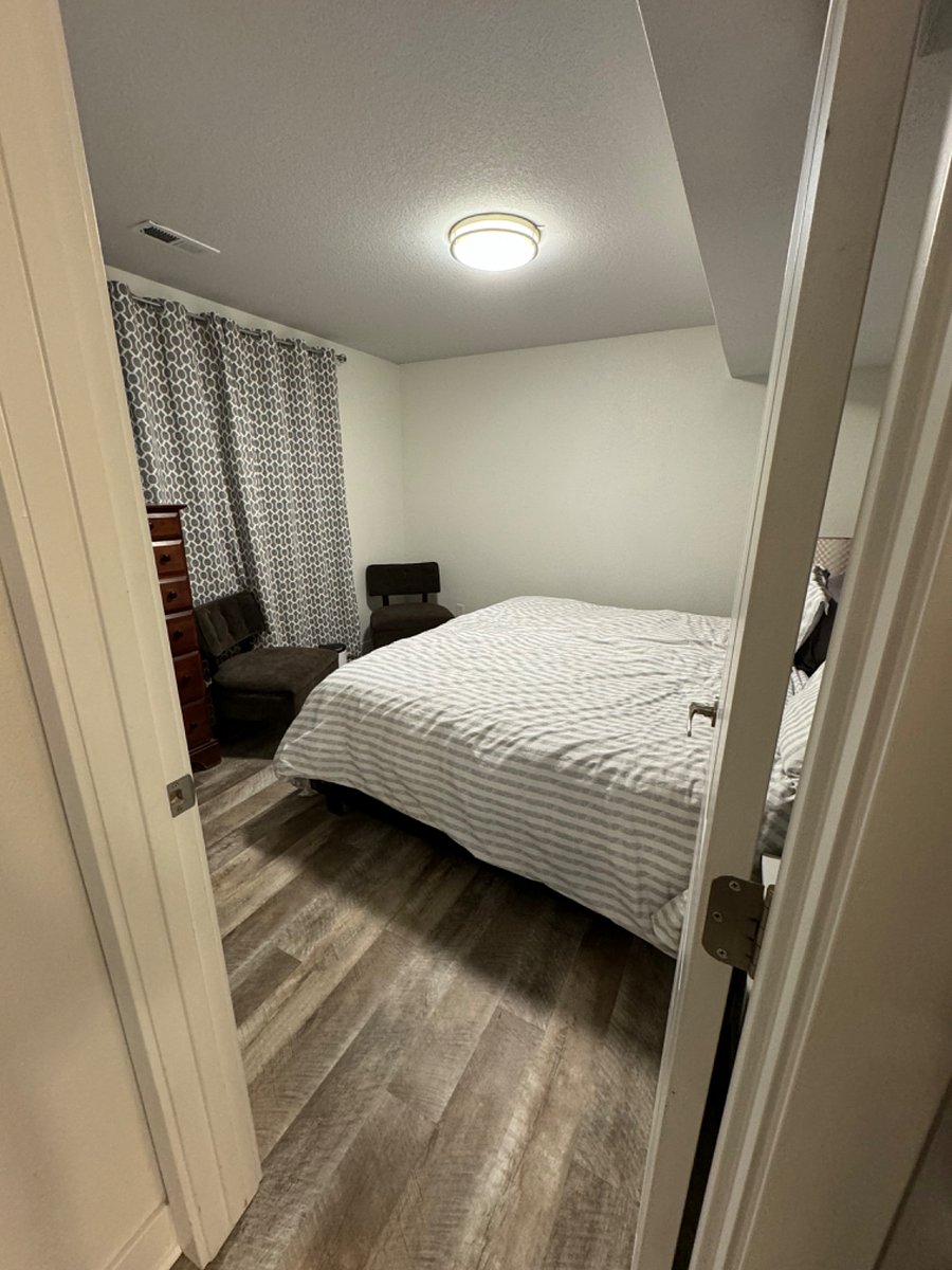 Bedroom with King Size Bed, Full Closet, Dresser and 2 Chairs