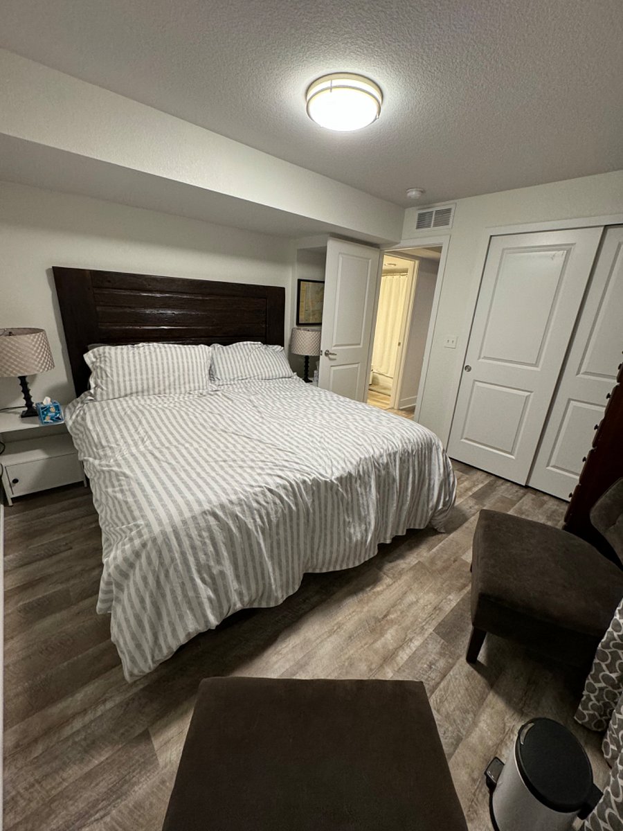 Bedroom with King Size Bed, Full Closet, Dresser and 2 Chairs
