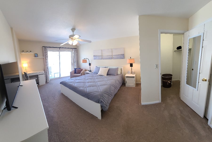 Master bedroom w/ desk area, natural light, walk in closet, and private walkout balcony w/ seating area.