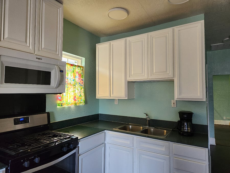 Full kitchen with lots of cabinets.