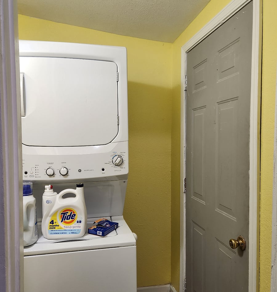Utility Room with washer and dryer. Back door is steel with an outer steel door with deadlock.