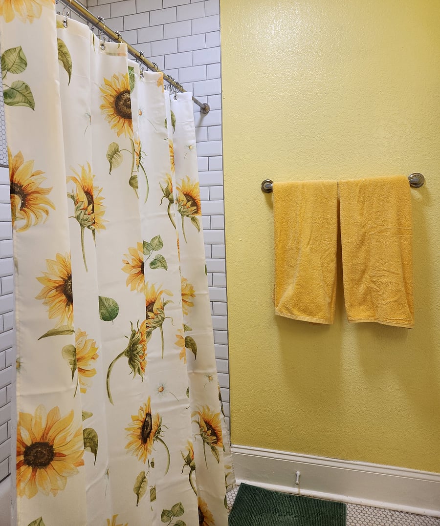 Sunny bathroom with full bath and shower.
