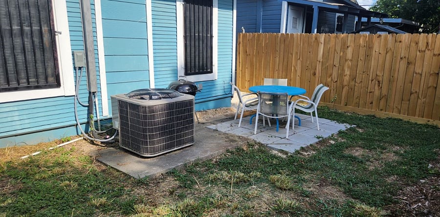 Private back yard with patio, table, chairs and grill.