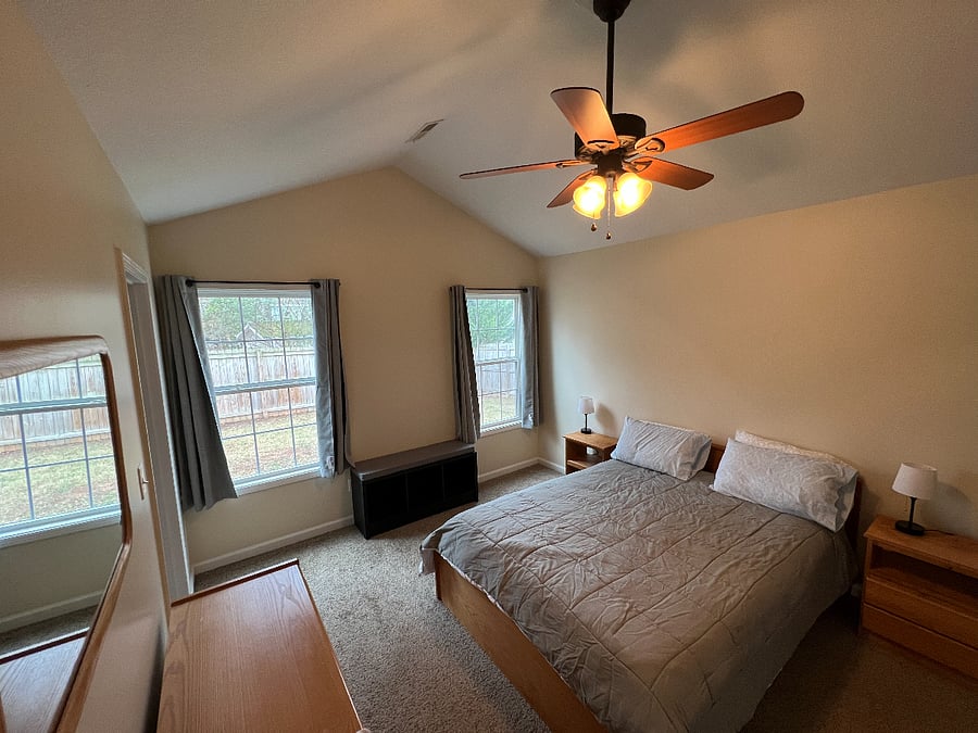 master bedroom with queen sized bed, walk in closet and full bath.