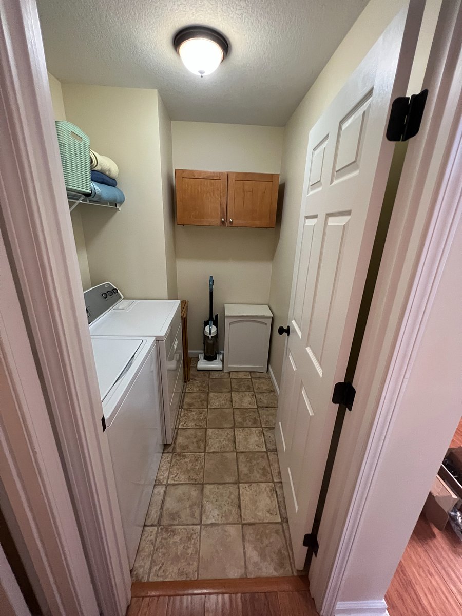 laundry room with washer/dryer, drying rack, hamper and built in storage.