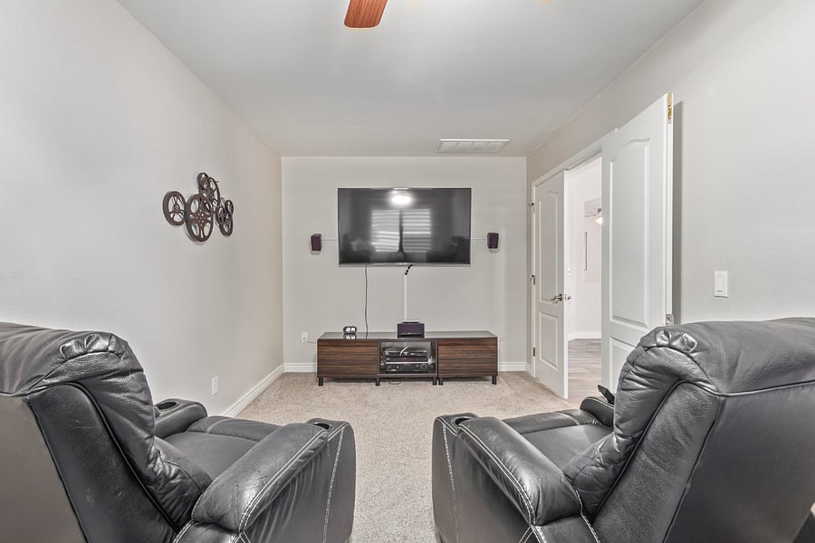 4th Bedroom (off the living room) has a Queen bed, nightstand, clothing tote shelf area, tv and 2 two media chairs.