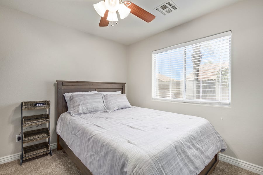 Bedroom 2 has a queen bed, accessory shelf, desk, dresser and a walk-in closet.