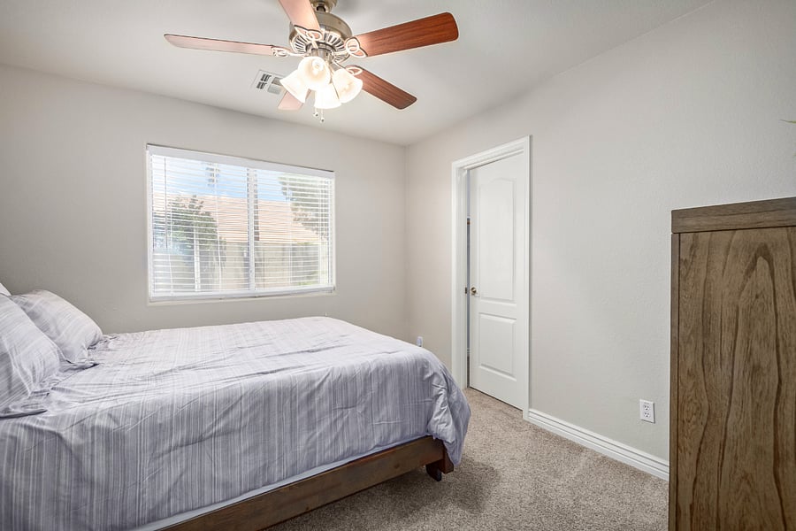 Bedroom 2 has a queen bed, accessory shelf, desk, dresser and walk-in closet.
