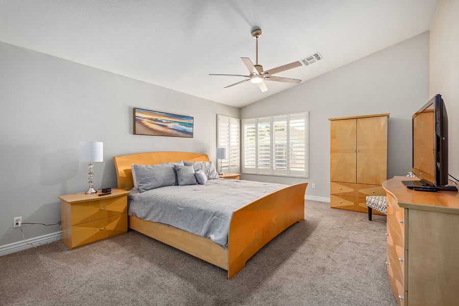 Primary Bedroom (Bedroom 1) has a King bed, 2 nightstands, chair, dresser, armoire and a tv.