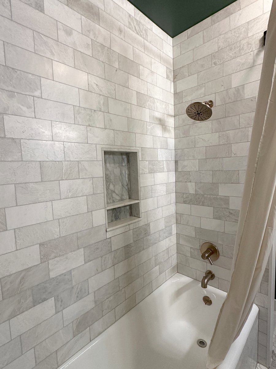 Double custom made walnut vanity and marble tile with orginal cast iron tub