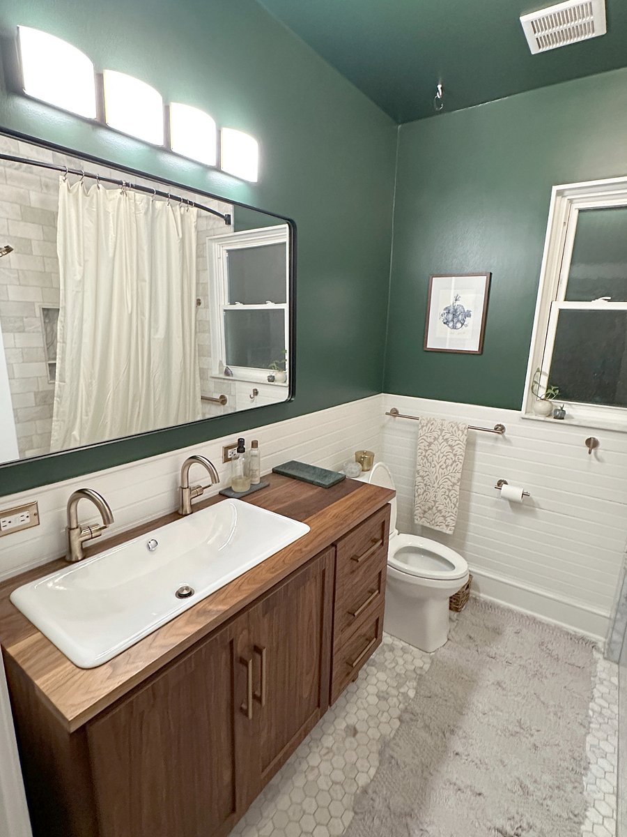 Double custom made walnut vanity and marble tile with orginal cast iron tub