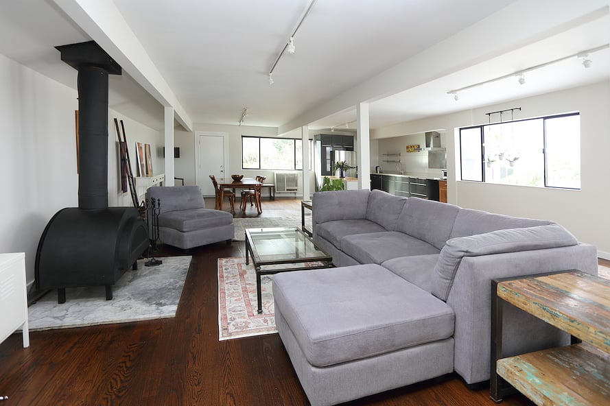 Freestanding fireplace opposite the sectional sofa.