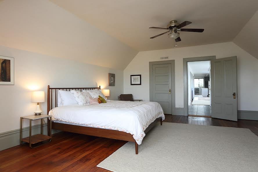 Bedroom with view down the hall to the main living area. 