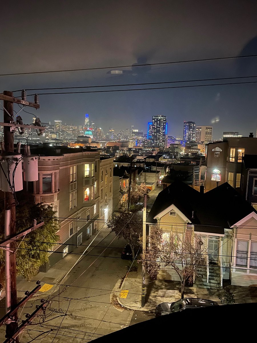 Stunning nightime view of City Hall, Salesforce Tower, and downtown San Francisco. 