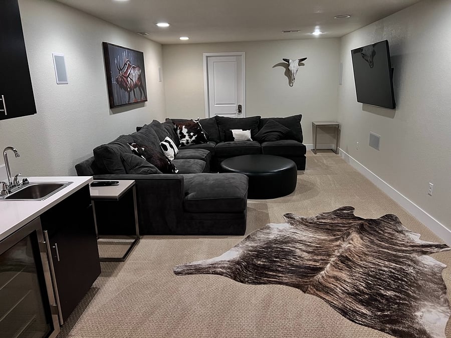Fully finished basement, mini bar, fridge and sink. Ful Bath and 3rd Bedroom. Couch pulls out to a queen bed. Large TV for movies. Micro wave at the bar.