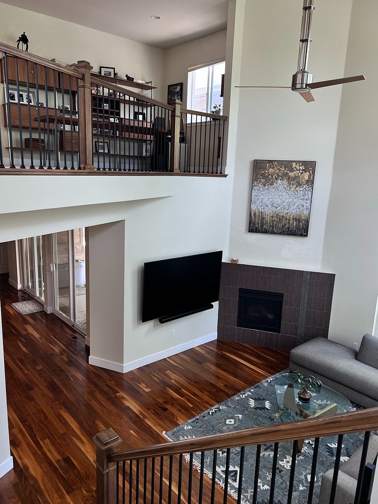 View of sitting room from first landing. Gas Fireplace, Room and Board Couch.