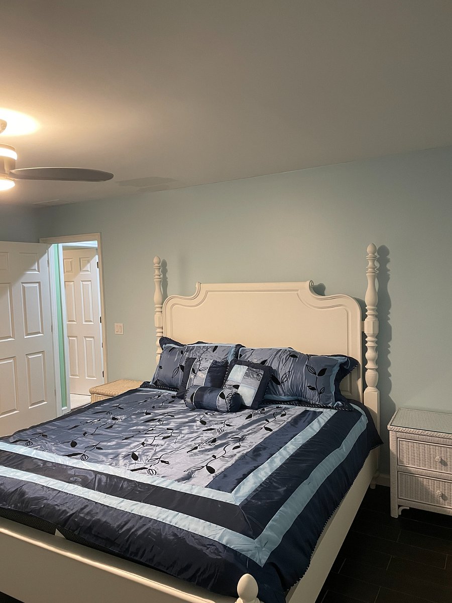 Master Bedroom containing a King Size Bed with two night stands and two dressers along with a walk in closet and bathroom.